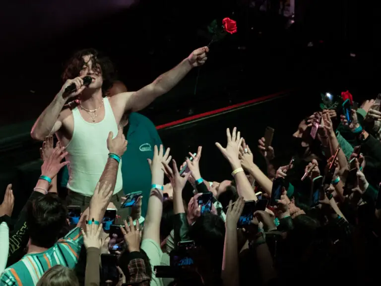 Alexander holding a rose to the crowd