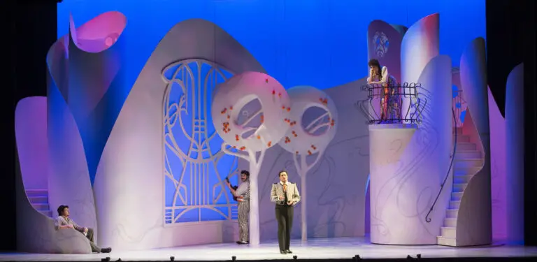 Four different performers on the stage during a presentation of The Barber of Seville.