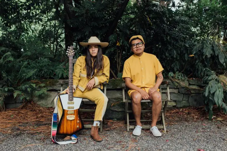 Fabiola Reyna and Sumohair of Reyna Tropical sitting in chairs in front of a tropical forest.