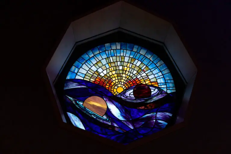 A spherical ceiling stained glass display of a solar system.