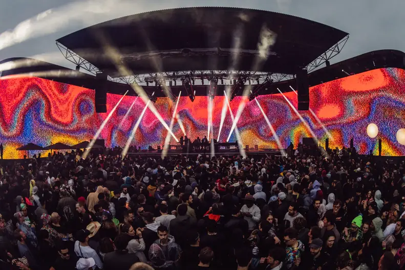 Fans at Brooklyn Mirage with screen projecting fuzzy swirly abstract art Brooklyn Mirage Fire CEO Josh Wyatt