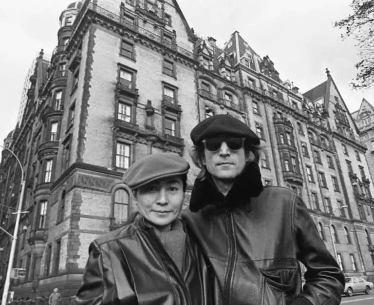 John Lennon and Yoko Ono outside the Dakota - Photo via Getty Images