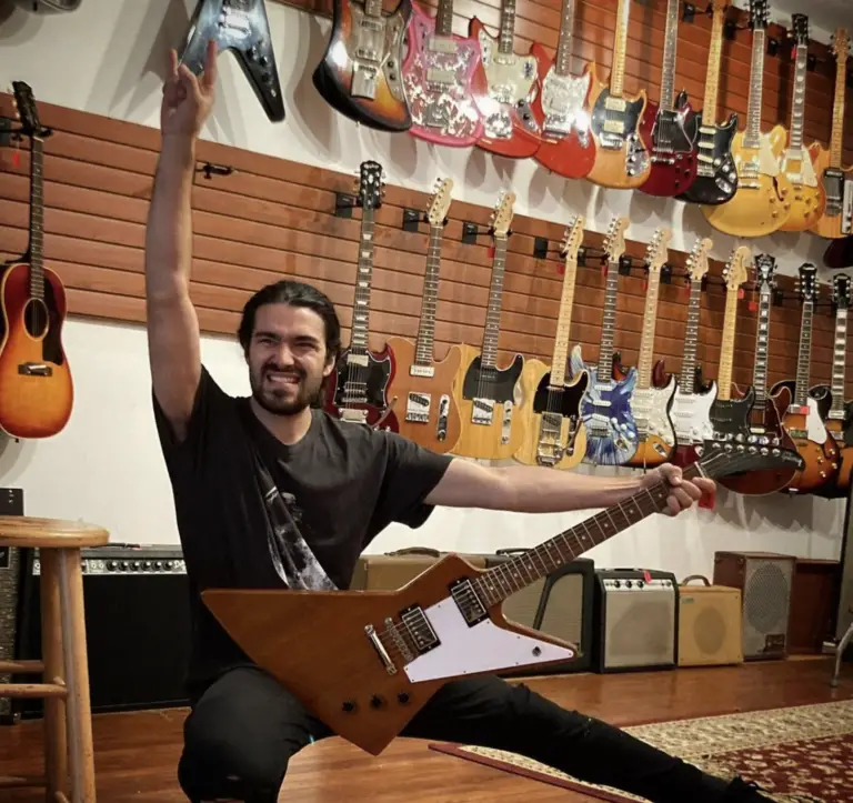 Division Street Guitar's Paulie Beladino poses for the store's Instagram page