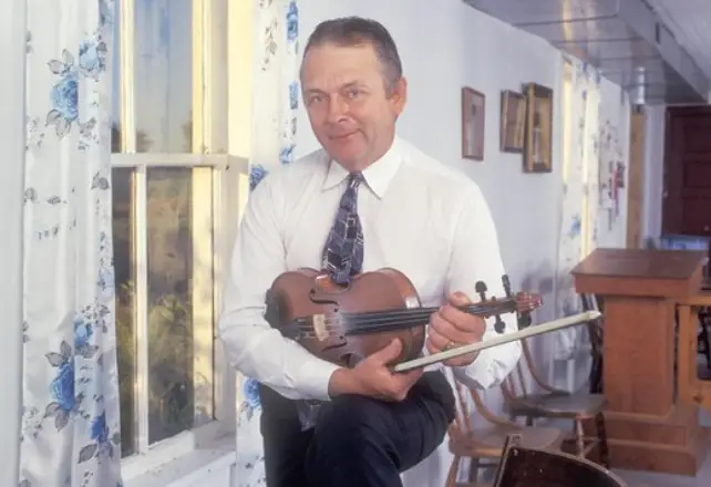 Don Woodcock, pictured with his fiddle in hand | Courtesy of TAUNY Archives/Martha Cooper