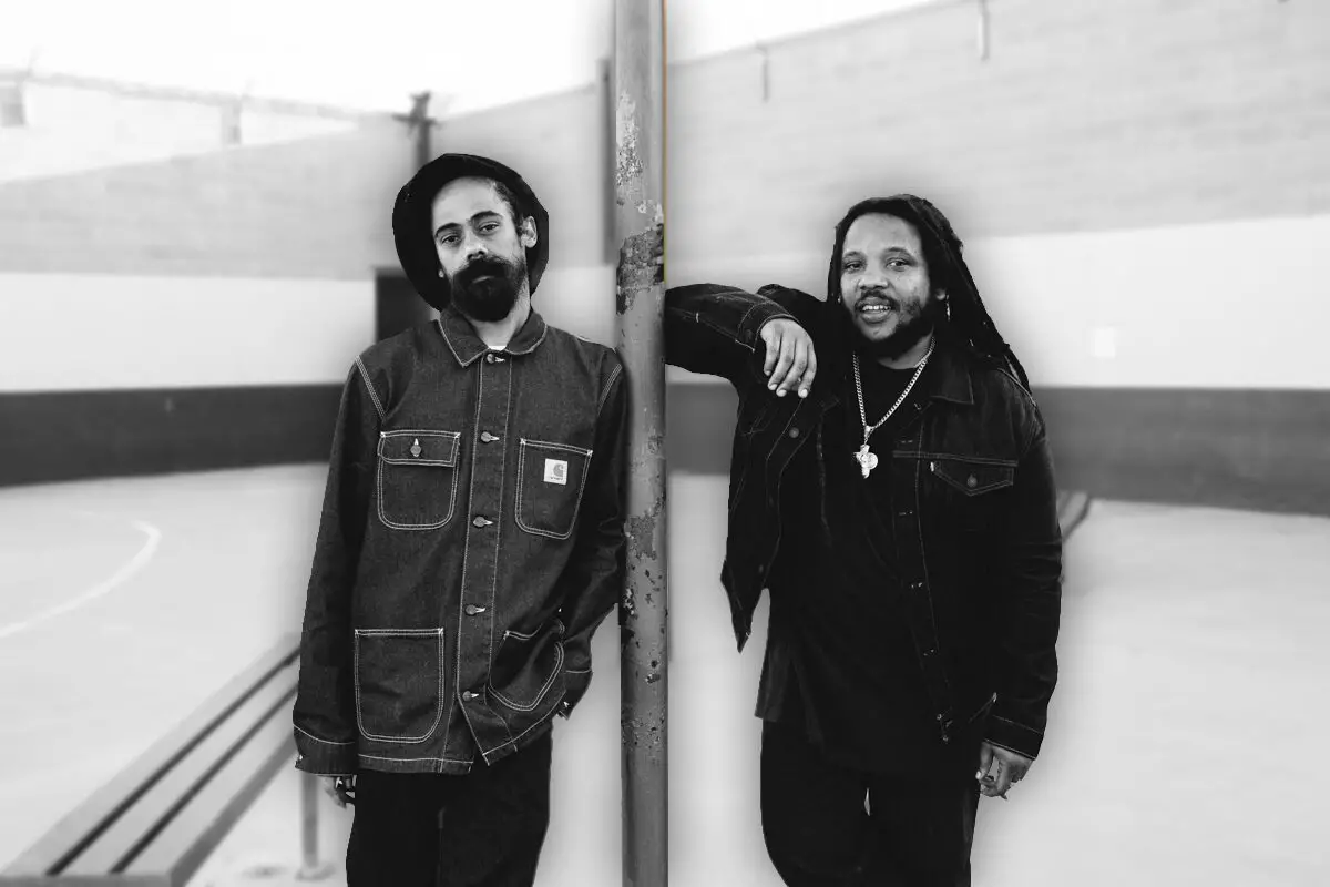 Marley brothers leaning on a pole, black and white photo.