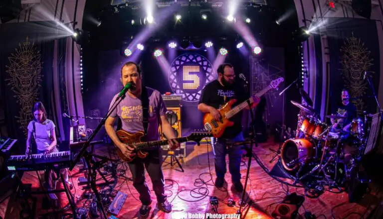 runaway gin playing on stage at a concert with purple lighting
