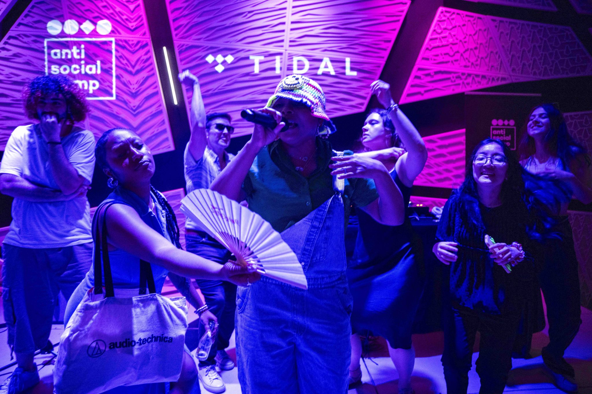 Crowd dancing alongside singer performing on stage