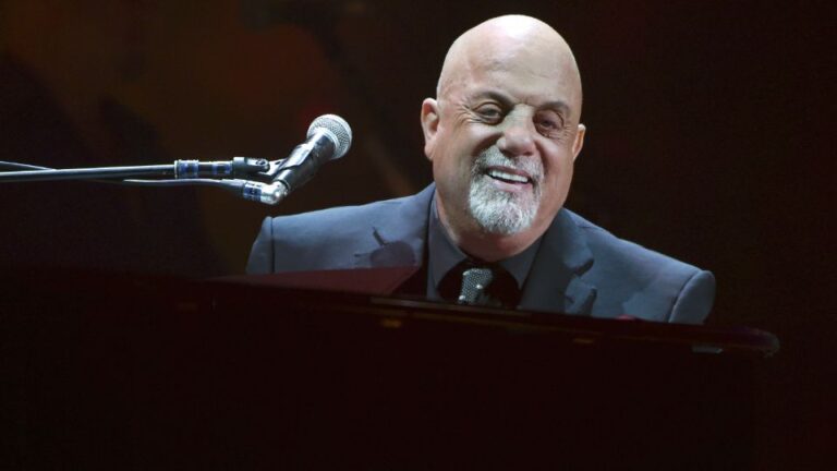 billy joel sitting and playing at piano