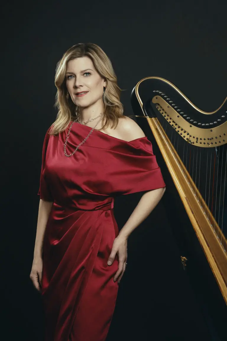 Kirsten Agresta Copely standing in front of harp