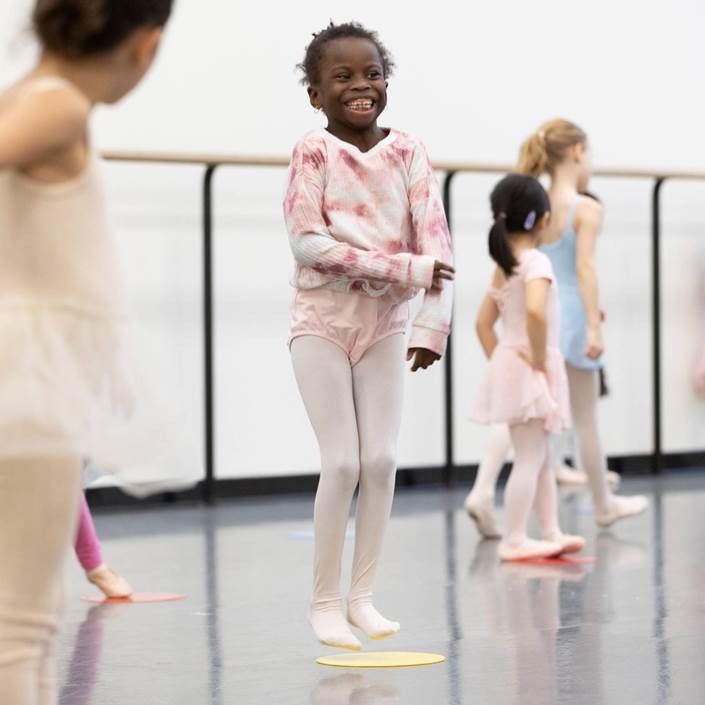 Young child jumping in dance studio