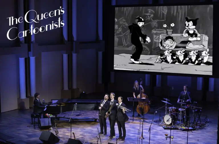 The Queen's Cartoonists performing on stage