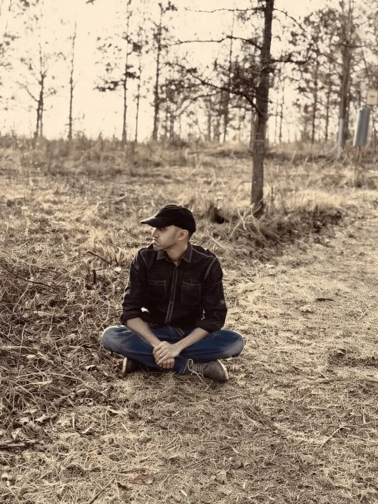Hari Vasan sitting on the ground outside